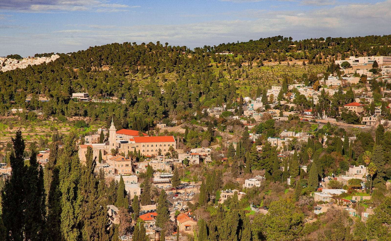 Panoramic view of Ein Karem, a mountain village-turned-Jerusalem neighborhood. Left of center is the Church of Saint John the Baptist. Photo by Tombah via Wikimedia Commons