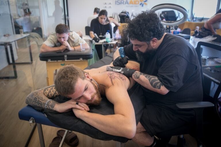 US and Israeli tattoo artists take park in the project tattooing survivors from the Supernova festival massacre. Photo by Miriam Alster/Flash90
