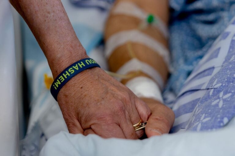 Susan Newman holding hands with her husband, Danny, after the surgery. Photo by John Jeffay