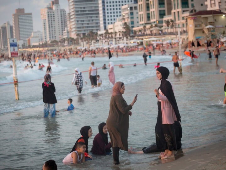 Arab women enjoy a day out on the beach in Tel Aviv. Photo by Miriam Alster/Flash90