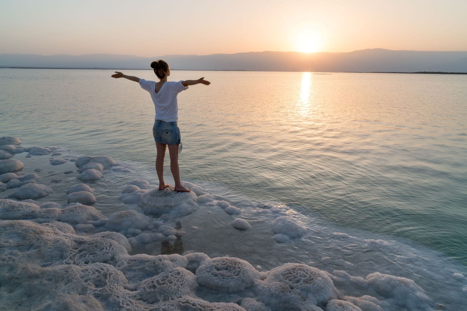 Meeting the sunrise on the shore the Dead Sea in Israel. Photo by fokusgood via Shutterstock.com