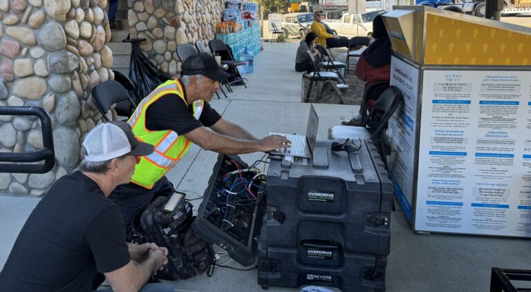 SmartAID workers installing communications equipment for LA first responders. Photo courtesy of SmartAID