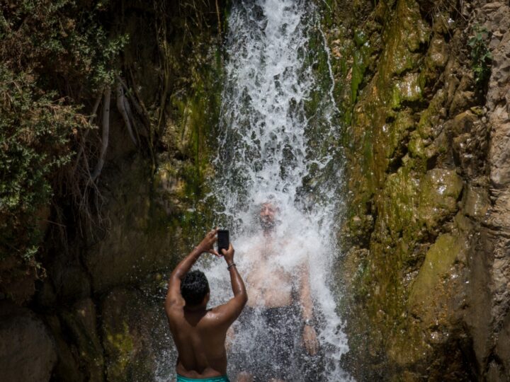 Tourists enjoy the Nahal David waterfall in Ein Gedi. Photo by Yonatan Sindel/Flash90