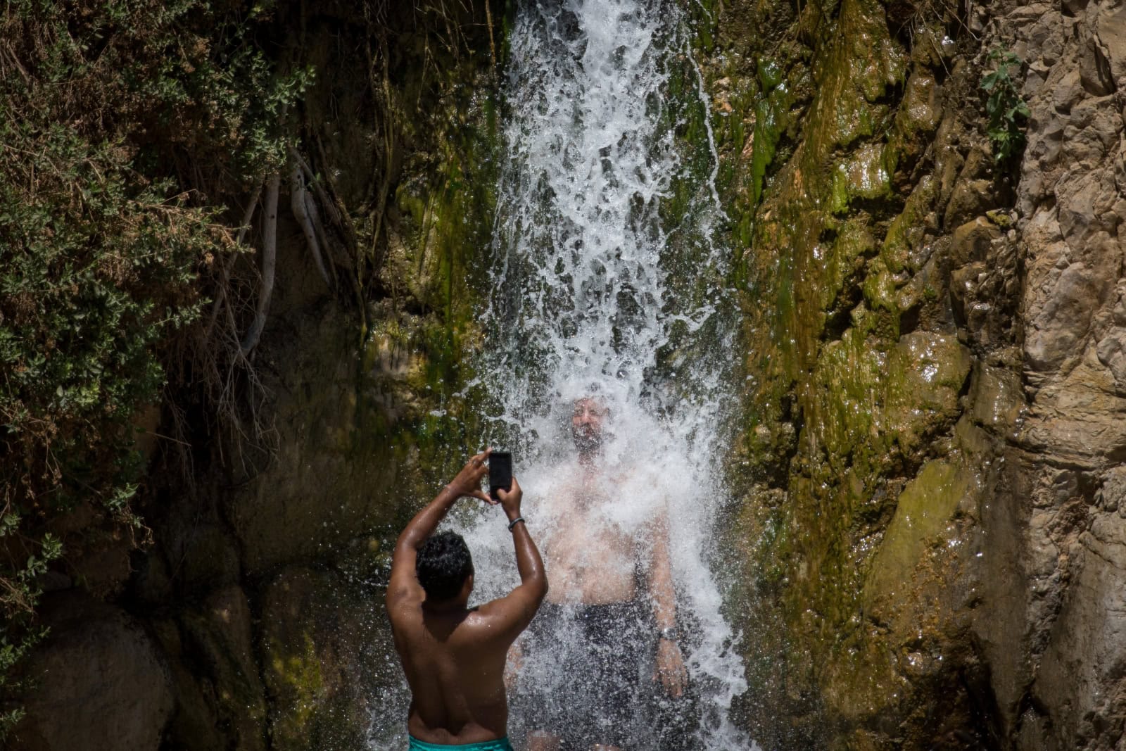 Tourists enjoy the Nahal David waterfall in Ein Gedi. Photo by Yonatan Sindel/Flash90
