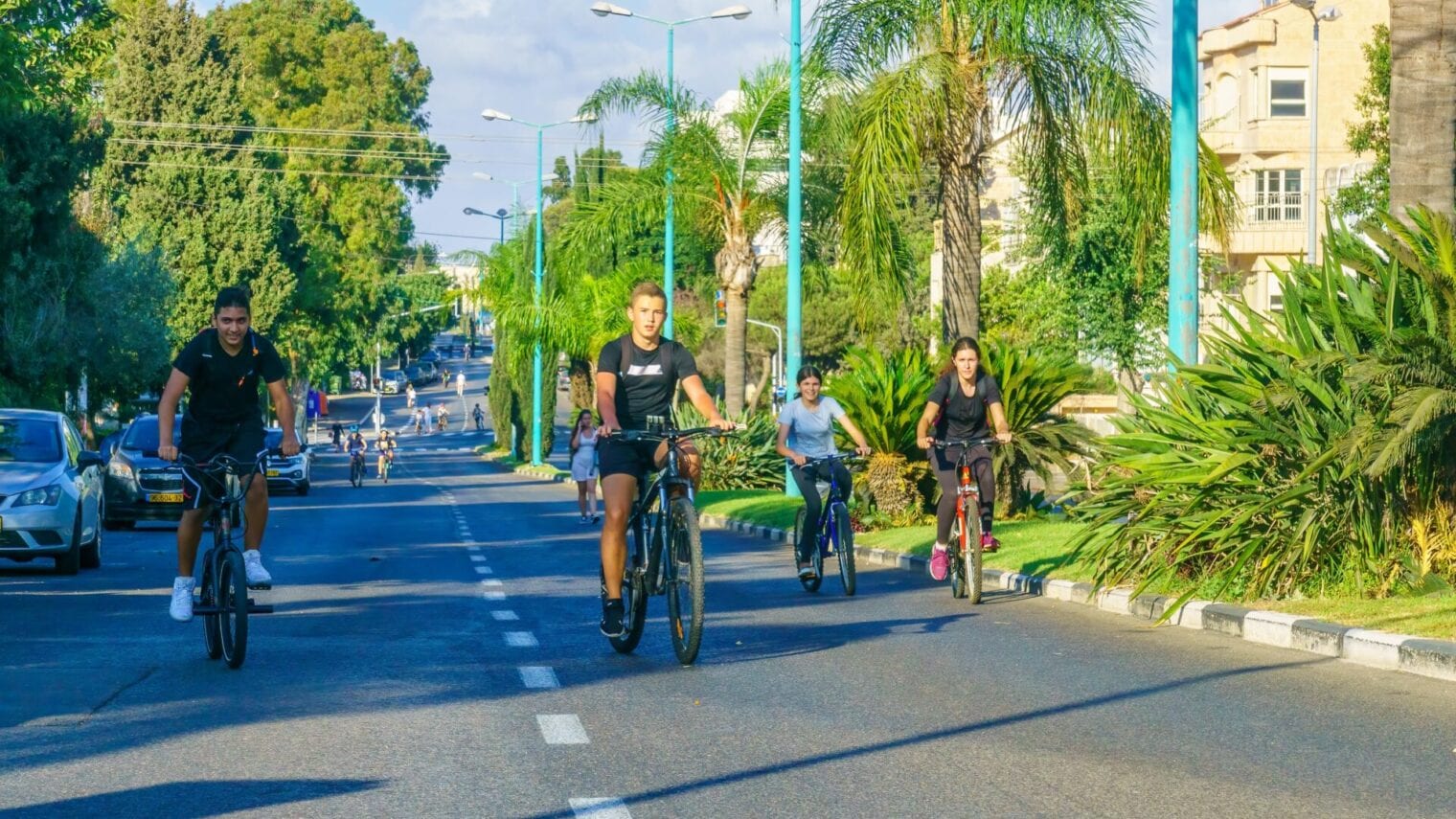 Israelis take to the deserted streets on Yom Kippur. Photo short in Haifa by RnDms, via Shutterstock