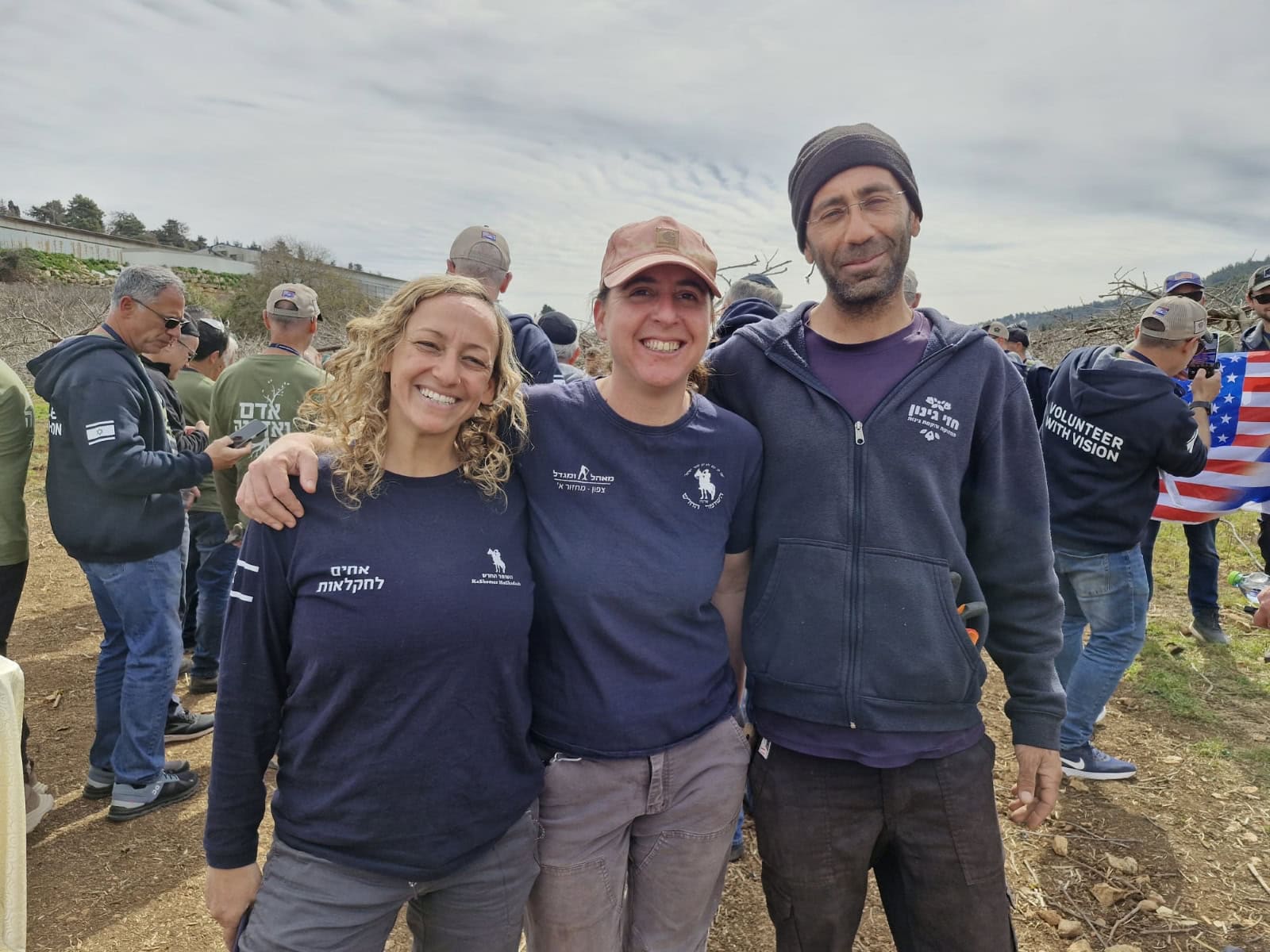 Kiwi farm owner Hezi Mena (far right) with two HaShomer HaChadash volunteers. Photo courtesy of HaShomer HaChadash