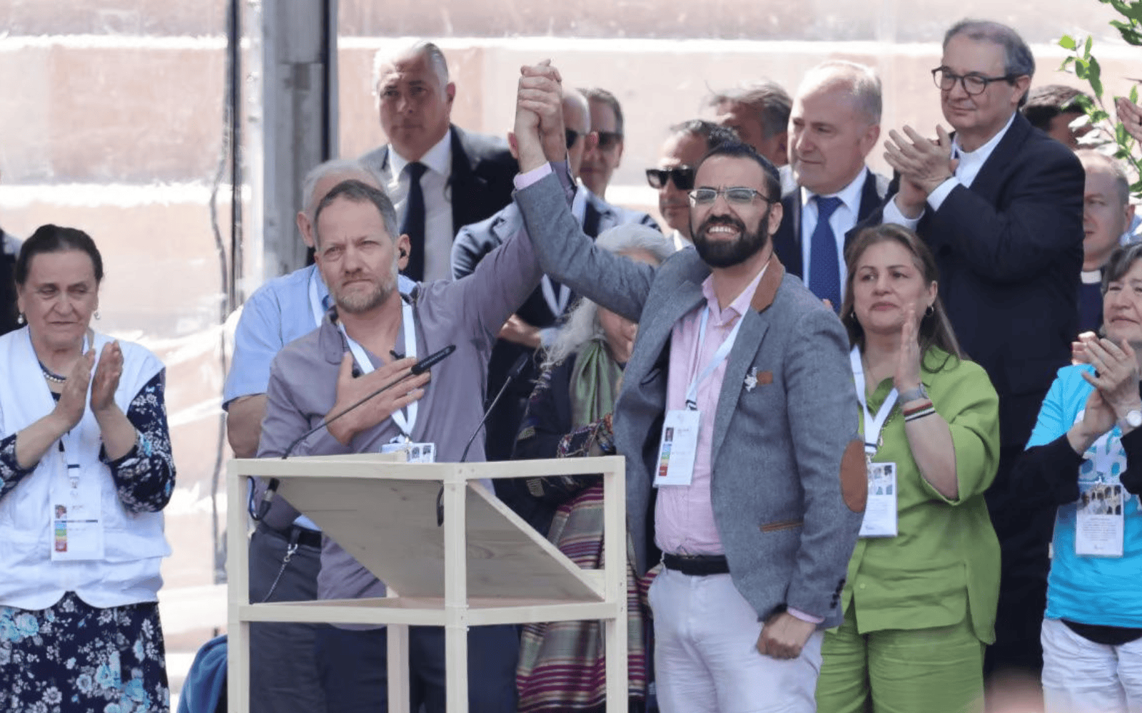 Middle East peace advocates Maoz Inon, left, and Aziz Abu Sara clasp hands. Photo courtesy of Maoz Inon